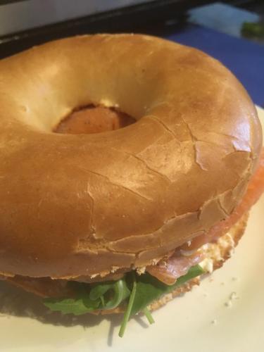 a bagel sandwich sitting on top of a plate at Elmdon Lodge in Birmingham
