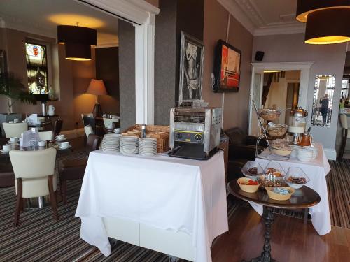 a kitchen with a table with a microwave on it at The York Hotel in Weston-super-Mare