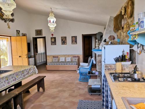 a kitchen with a counter and a kitchen with a stove at Villa Walter in Oliena