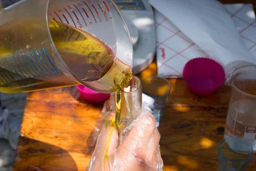 a person pouring food into a glass bottle at Princess Lanassa in Kostitsi