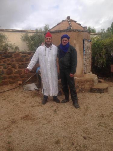 a man and woman standing in front of a building at Ferme D"Hote Lala Fatima in Aïn Leuh