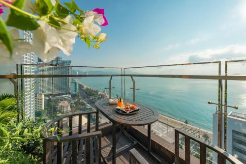 
a dining room table with a view of the ocean at Maple Hotel & Apartment in Nha Trang
