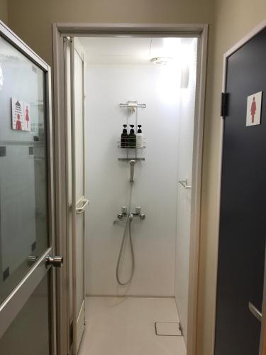 a bathroom with a shower with a glass door at Tokyo Guest House Itabashi-juku in Tokyo