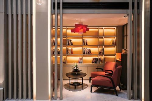 a living room with a chair and a table at Harbin Week Inn Hotel in Harbin