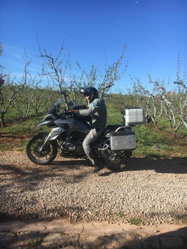 a man riding a motorcycle on a gravel road at Ferme D"Hote Lala Fatima in Aïn Leuh
