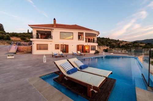 a villa with a swimming pool and a house at Jessica Luxury Villa in Agios Nikolaos