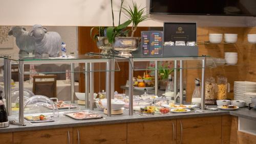 a buffet with plates of food on a counter at Hotel Lamm in Waiblingen