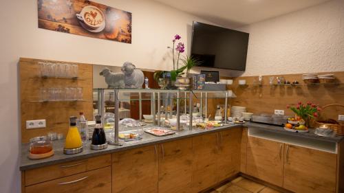 a kitchen with a counter with food on it at Hotel Lamm in Waiblingen