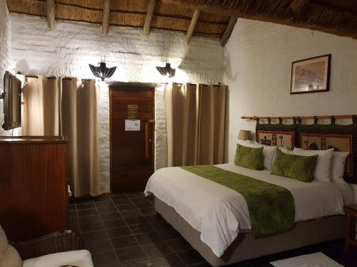 a bedroom with a large bed in a room at Misty Hills Country Hotel, Conference Centre & Spa in Muldersdrift