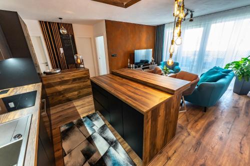 a kitchen with a wooden counter top in a room at More Than Accommodation in Bratislava