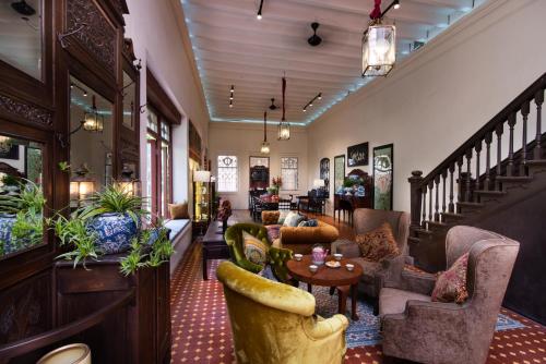 a lobby with couches and chairs and a table at Muntri Mews in George Town