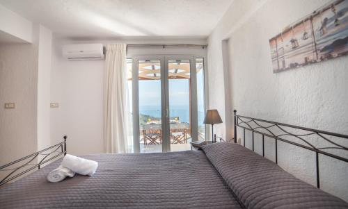 a bedroom with a bed with a view of the ocean at Halcyon Panorama Villas in Agios Nikolaos