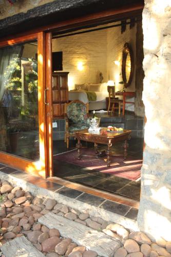 a living room with a couch and a table at Misty Hills Country Hotel, Conference Centre & Spa in Muldersdrift