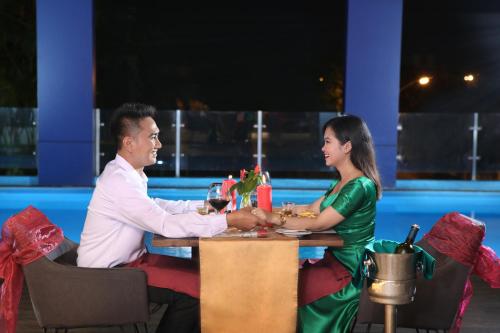 a man and a woman sitting at a table at Swiss-Belinn Modern Cikande in Serang