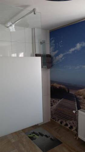 a bathroom with a shower with a mural of a beach at Ferienwohnung Hirmer in Zirndorf