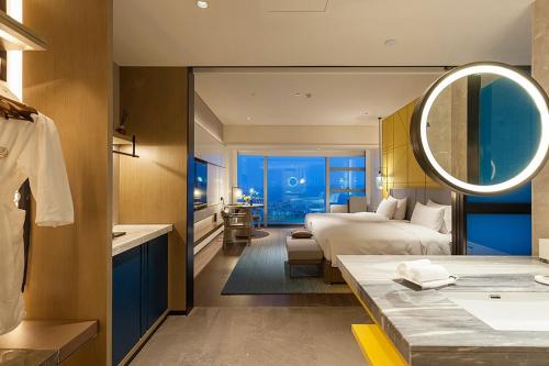 a hotel room with a bed and a bathroom at Tianyuan Grand Hotel Xiamen in Xiamen