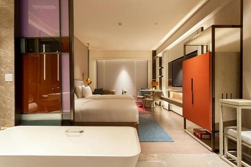 a hotel room with two beds and a bathroom at Tianyuan Grand Hotel Xiamen in Xiamen
