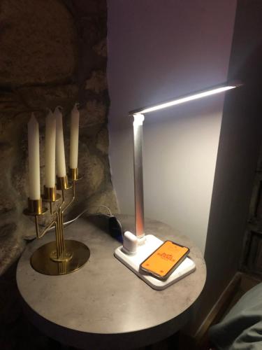 a lamp on a table with a book and candles at Ca' del Borgo in Venosa
