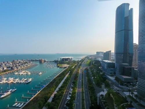 an aerial view of a city with a marina at Tianyuan Grand Hotel Xiamen in Xiamen
