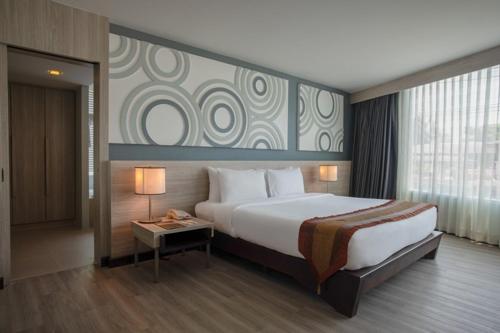 En eller flere senge i et værelse på Nora Chaweng Hotel