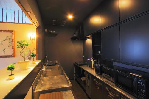 a kitchen with a stainless steel sink and a counter at Fujinokura Tiny Fort in Fujiyoshida