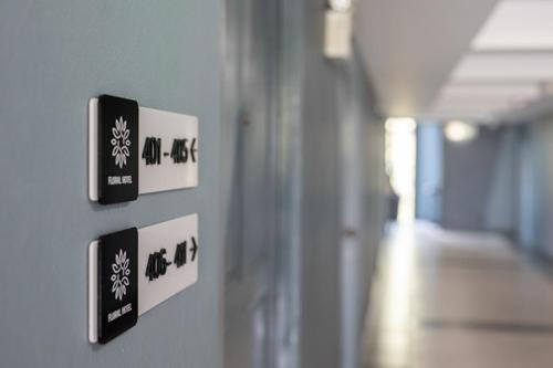 a wall with signs on a wall in a hallway at Nora LakeView in Chaweng