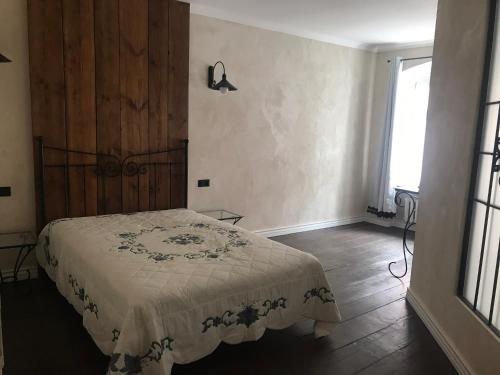 a bedroom with a bed with a blanket on it at Apartament Rustical in Wrocław