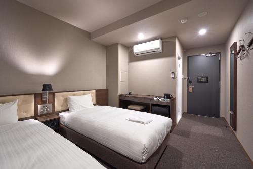 Welina Hotel Premier Shinsaibashiにあるベッド