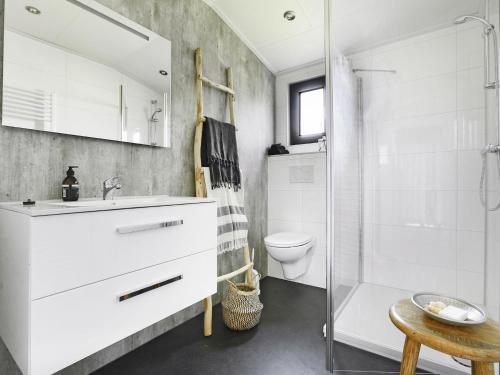 a bathroom with a sink and a toilet and a shower at Chalet in Zell am See near Ski Slope in Markelo