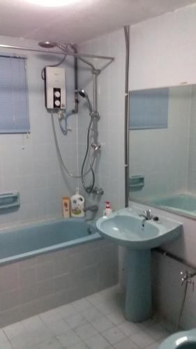 a bathroom with a sink and a bath tub and a sink at Beachfront@The Regency, Tanjung Tuan Beach Resort, Port Dickson, Malaysia in Port Dickson