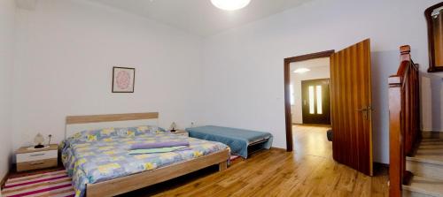 a bedroom with a bed and a door to a hallway at Apartman Aurora in Poreč