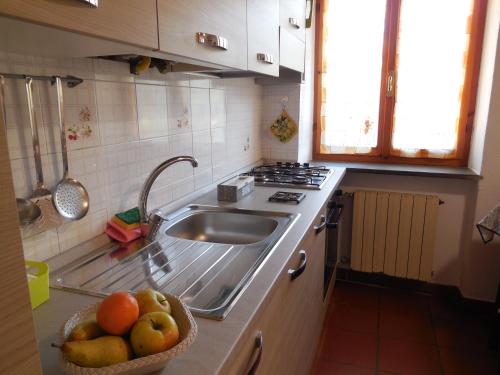 a kitchen with a sink and a bowl of fruit at vignale holiday house in La Spezia