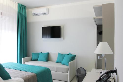 a hotel room with a bed and a couch at Park Hotel Giusy in Lido di Camaiore