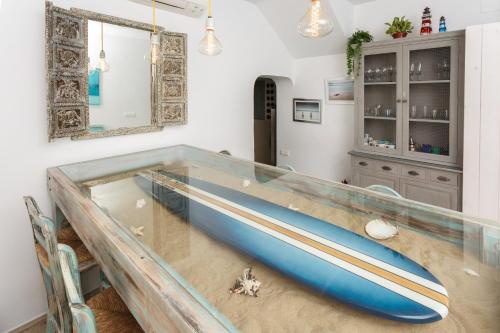 a glass table with a blue canoe on top of it at Alamar 1 Burriana in Nerja