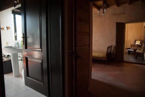 an open door to a room with a sink and a table at Corte Mantovanella in SantʼAntonio
