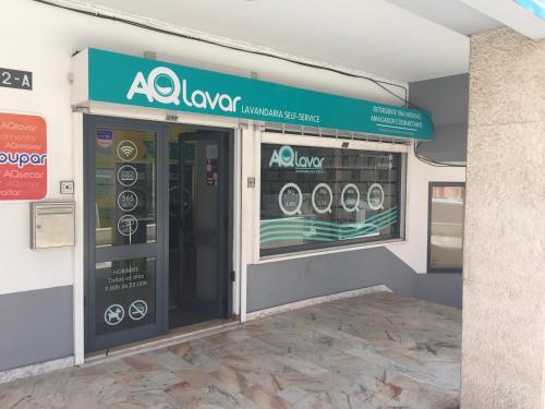 a sign over a door of a appliance store at Paradise Suites in Carcavelos