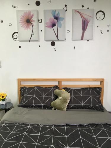 a bedroom with a bed with pictures on the wall at Woodsbury Suites 7722 Butterworth Penang in Butterworth