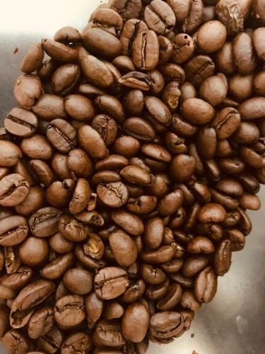 a pile of coffee beans in a bowl at Hotel Villa Carmen in Malcesine