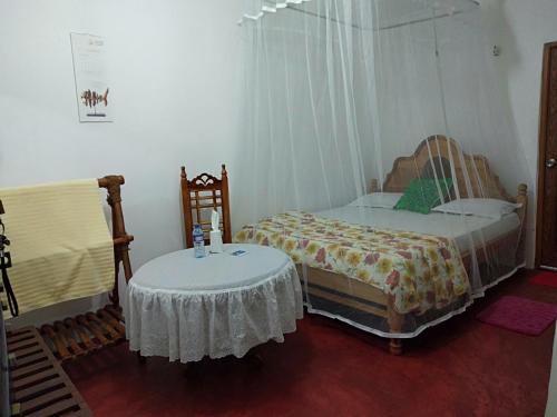 a bedroom with two twin beds and a table at Homeaway Homestay Hatton in Hatton