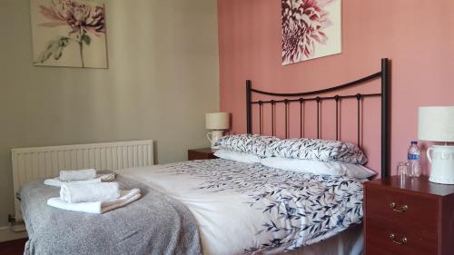 a bedroom with a bed with two towels on it at The Bugle Inn in St Austell