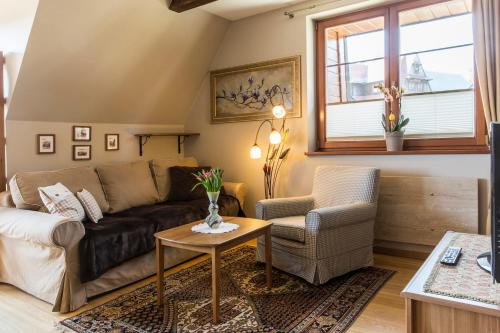 a living room with a couch and a table at Apartment Tiffany in Nowe Bystre