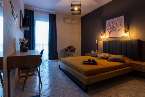 a bedroom with a large bed and a desk in it at Horizon Studios - Apartments in Rodakino
