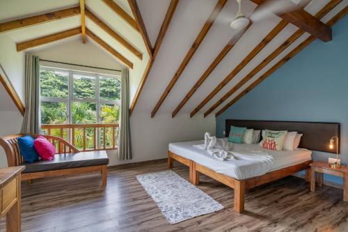 a bedroom with a bed and a window at La Modestie Guest House in Grand'Anse Praslin