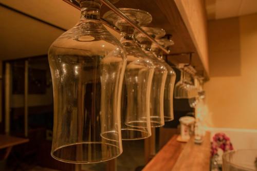 a group of glass bottles hanging on a wall at La Vista Hotel Tsugaike - Stay on the Slopes in Otari