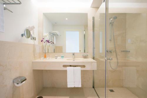a bathroom with a sink and a shower at Hipotels Barrosa Garden in Chiclana de la Frontera