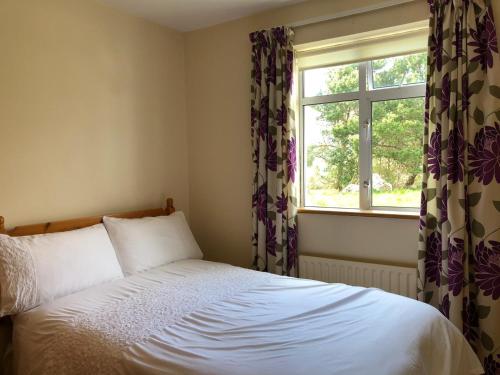 Schlafzimmer mit einem Bett und einem Fenster in der Unterkunft Lake View Cottage in Flannery Bridge