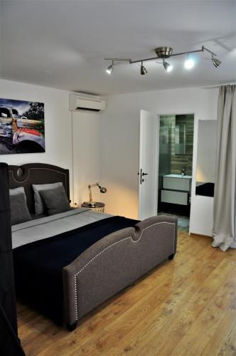 a bedroom with a large bed and a bathroom at La Rabla in Dubova