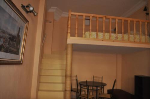 a staircase leading up to a room with a table and a stair case at Studio Mezzanine Kasbah Tanger - Climatise in Tangier