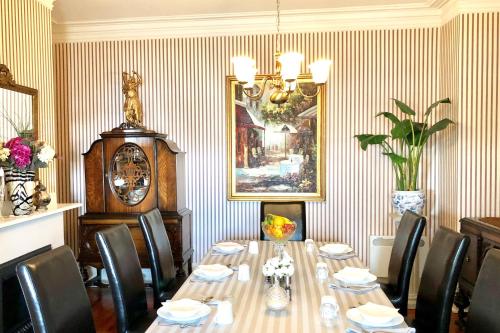 a dining room with a long table and chairs at Balmoral House Bed & Breakfast in St. John's
