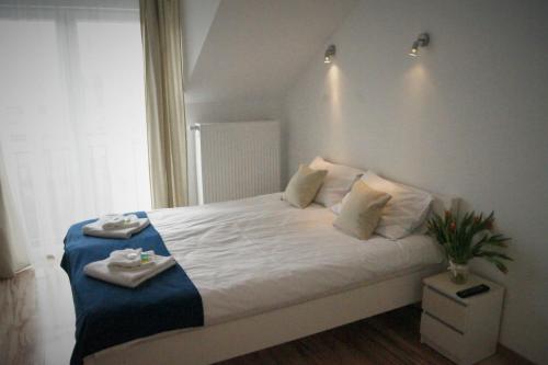 a bedroom with a bed with two towels on it at Willa Wena in Ustka